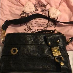Black handbag with brass buckles